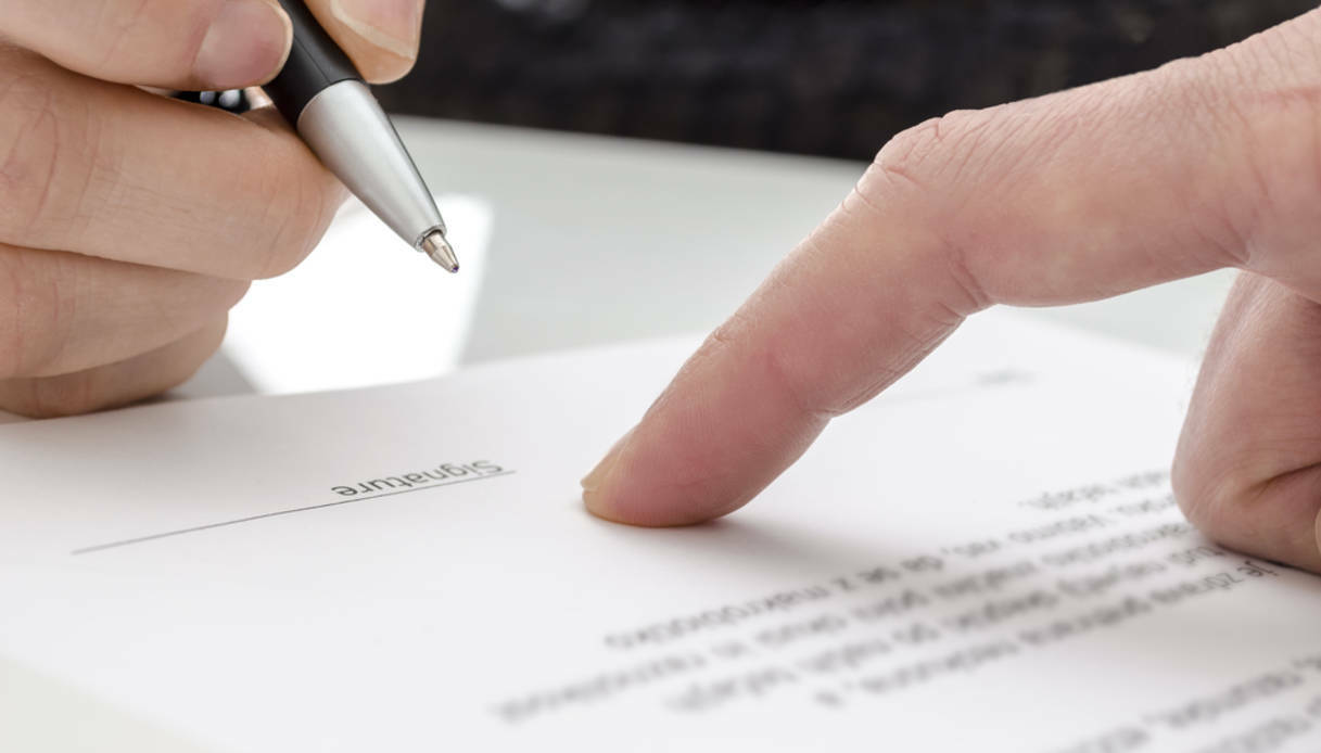 Woman signing a paper