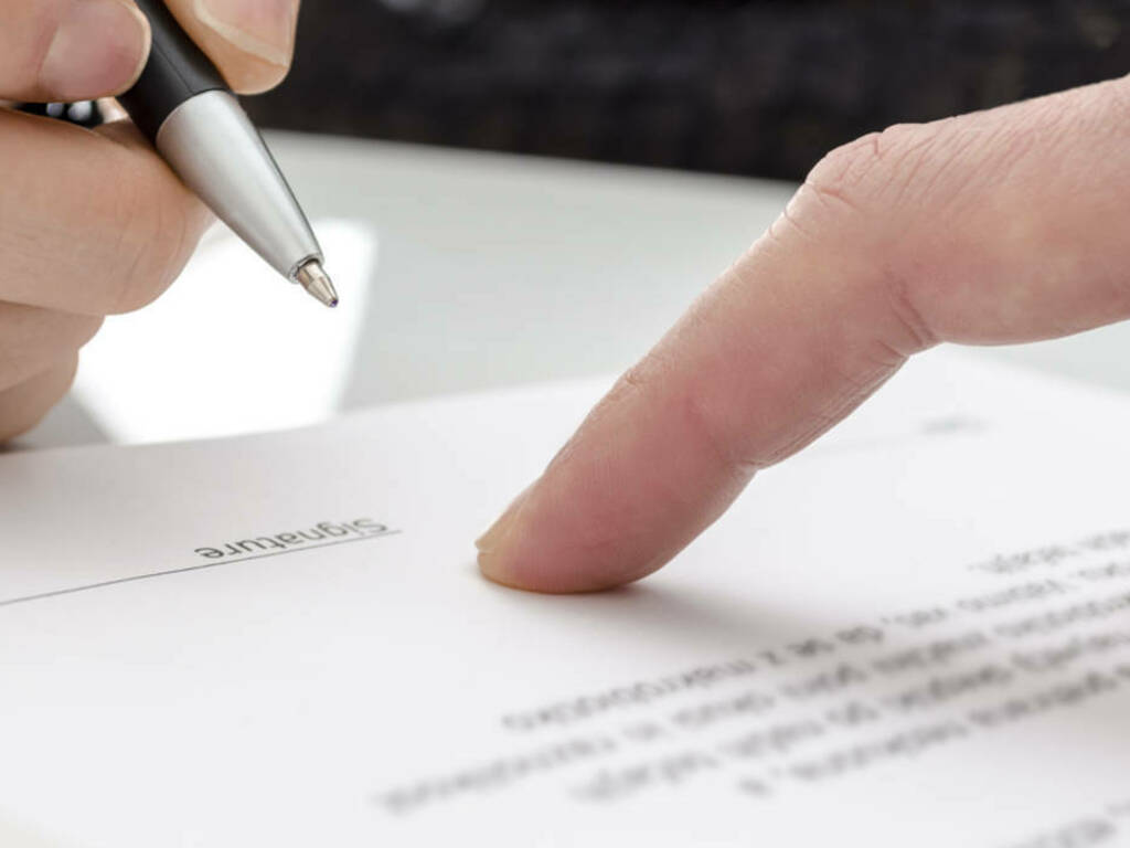 Woman signing a paper